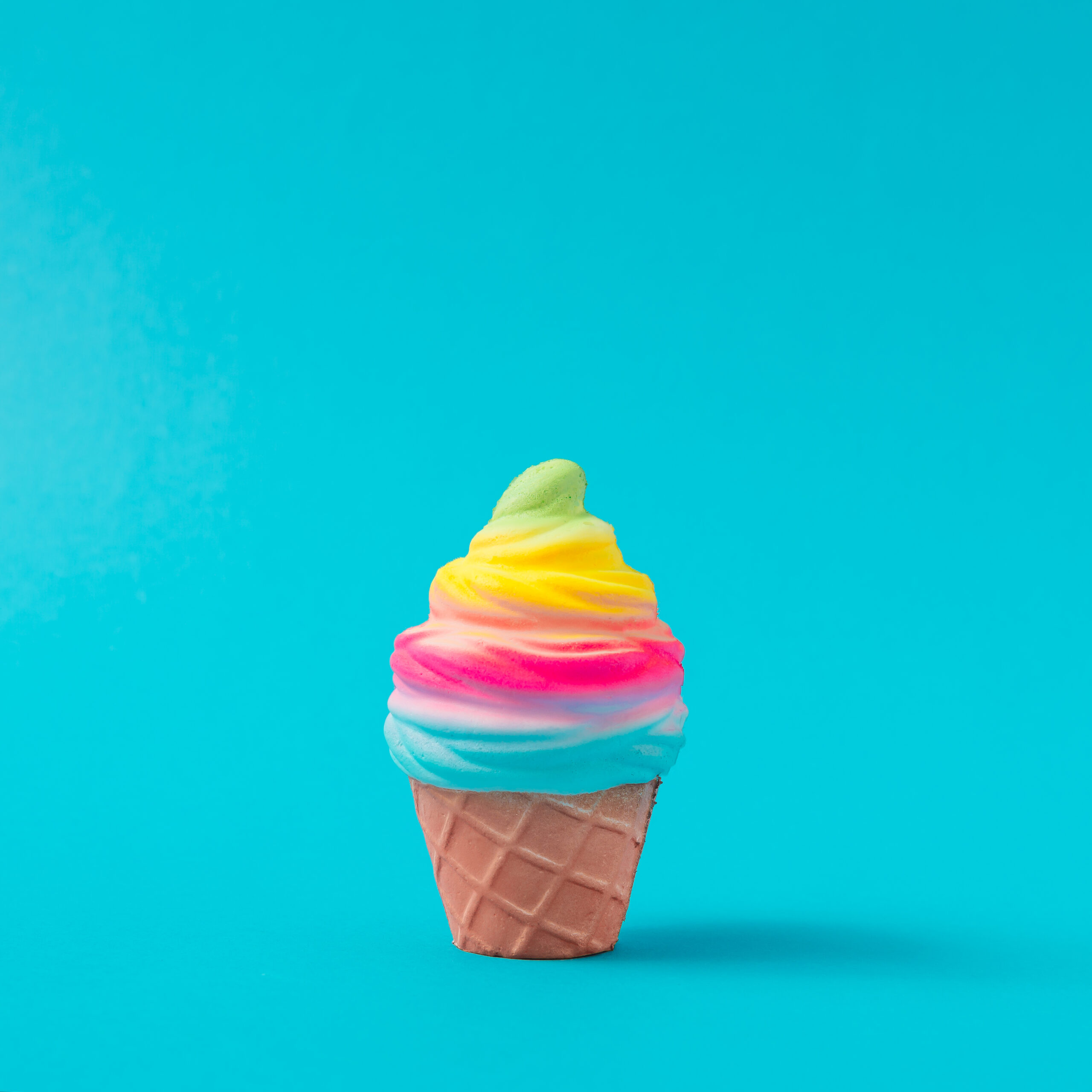Colorful and white ice cream on pastel blue background.  Creative minimal summer concept.