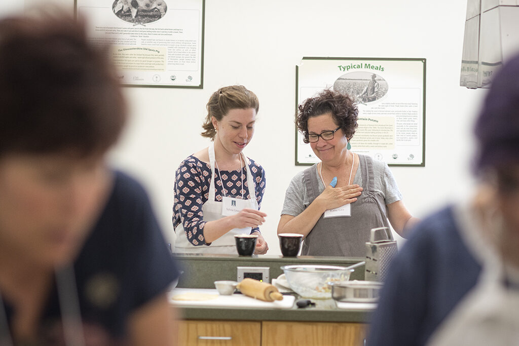 Two cooking class participants working at their station